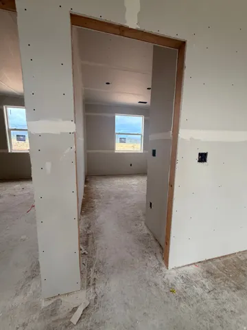 Interior framing showcasing multiple windows, recessed lighting, and an open doorway