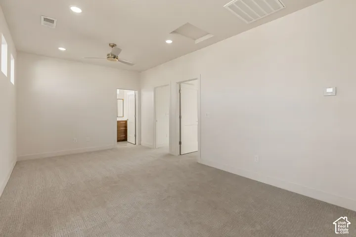 Room featuring neutral wall-to-wall carpeting, recessed ceiling lighting, a multi-speed ceiling fan, and solid-core interior doors