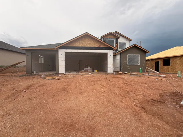Multi-level exterior framing with two distinct garage bays