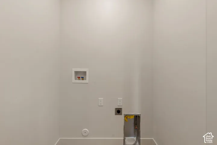 Dedicated utility space featuring laundry hookups, electrical outlets, and a vent connection