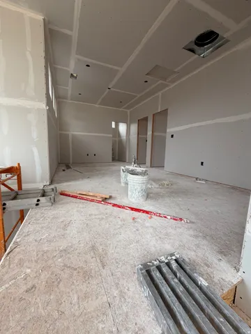 Spacious interior featuring high ceilings and multiple windows providing ample natural light