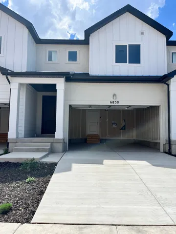 Contemporary townhome exterior featuring a contrasting black and white palette