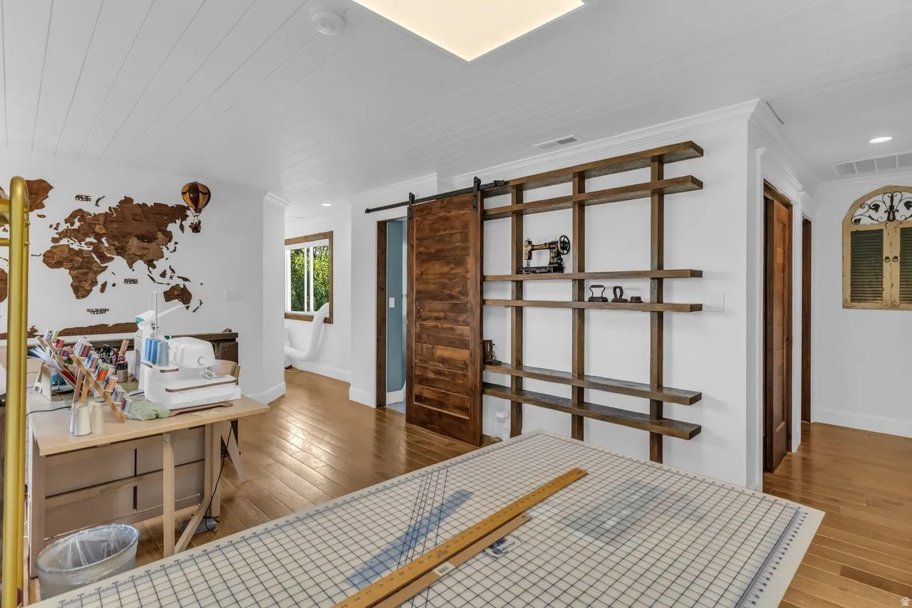 Custom barn door and a large custom built-in shelving unit