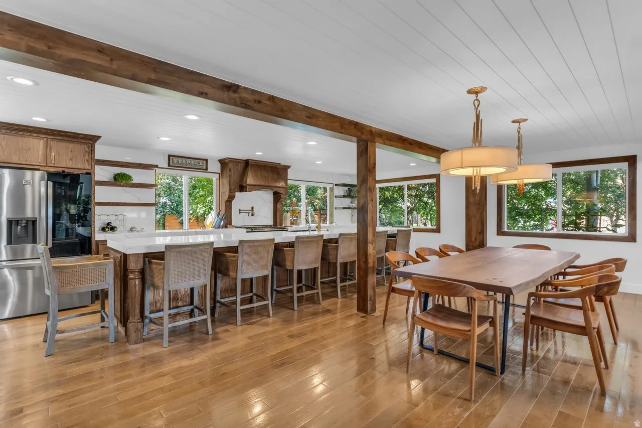 Expansive kitchen and dining area with hardwood flooring throughout and shiplap ceilings