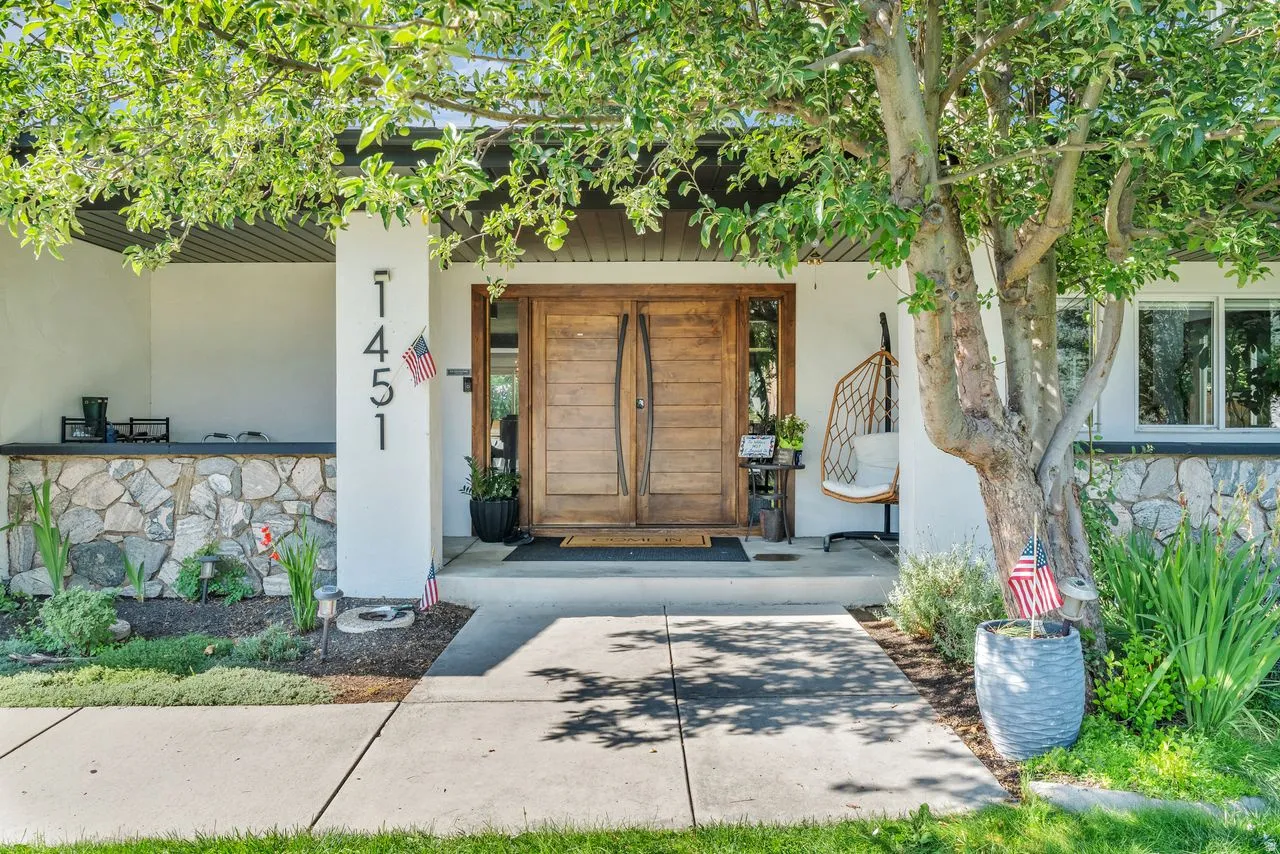Modern architectural entrance featuring custom wood double entry doors