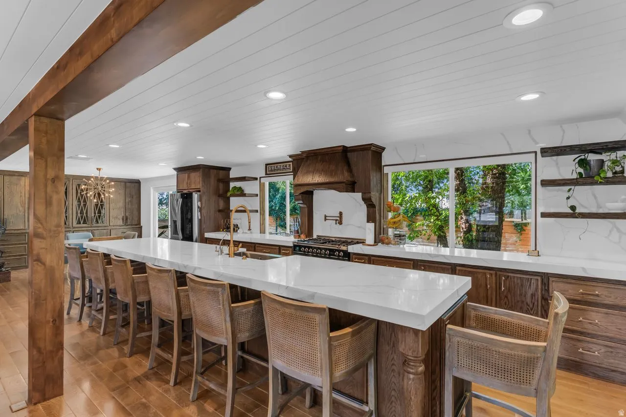 Spacious kitchen featuring a lengthy center island with included seating and recessed lighting