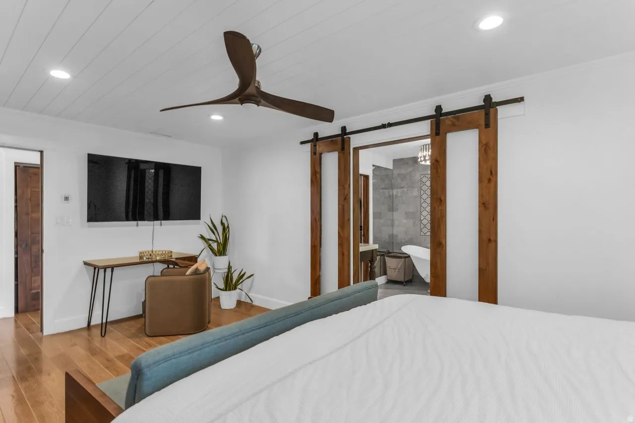 Primary suite featuring custom barn doors and ornate detail in the doorframes