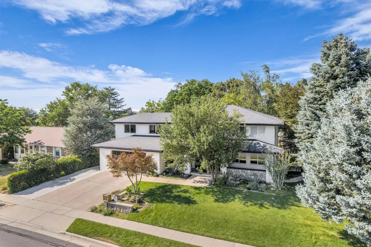 Two-story residence with mature trees surrounding
