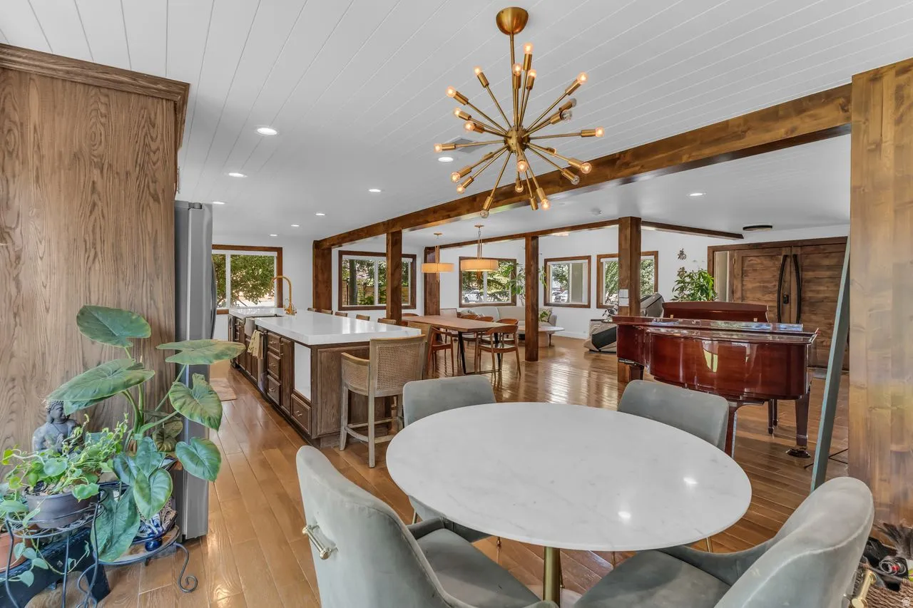 Complete open concept with wood beams and a contemporary sputnik chandelier