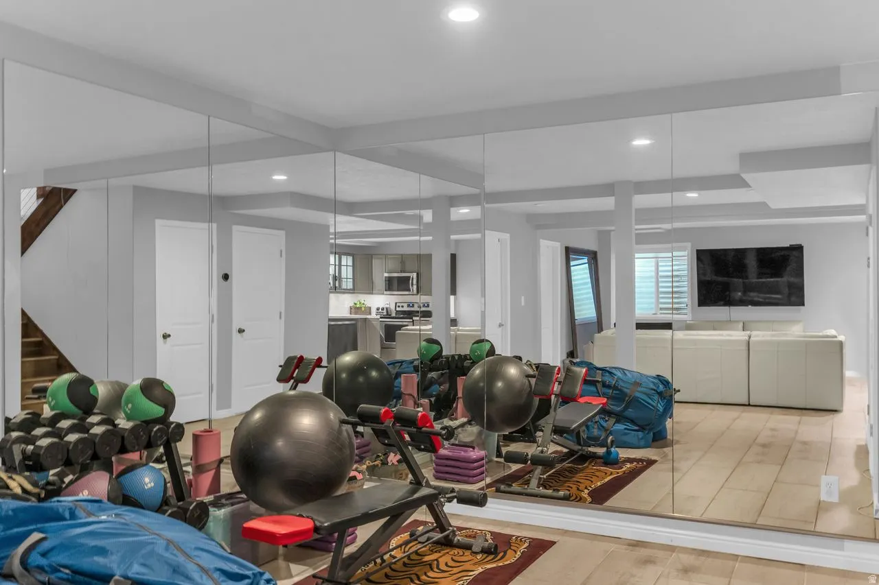 Gym area featuring mirrored walls