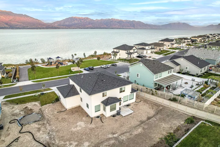 Modern residential property featuring a white exterior and dark shingle roof