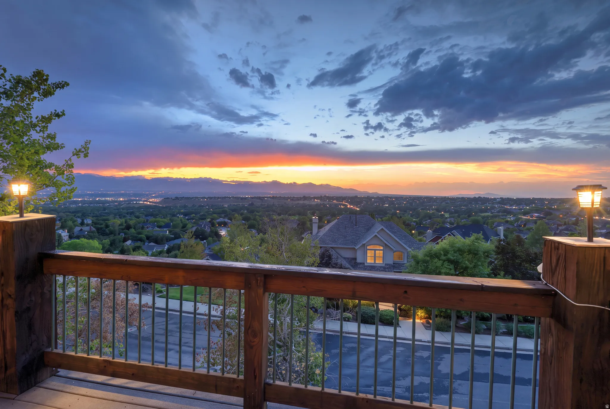 Expansive outdoor deck with a wooden railing and metal balusters