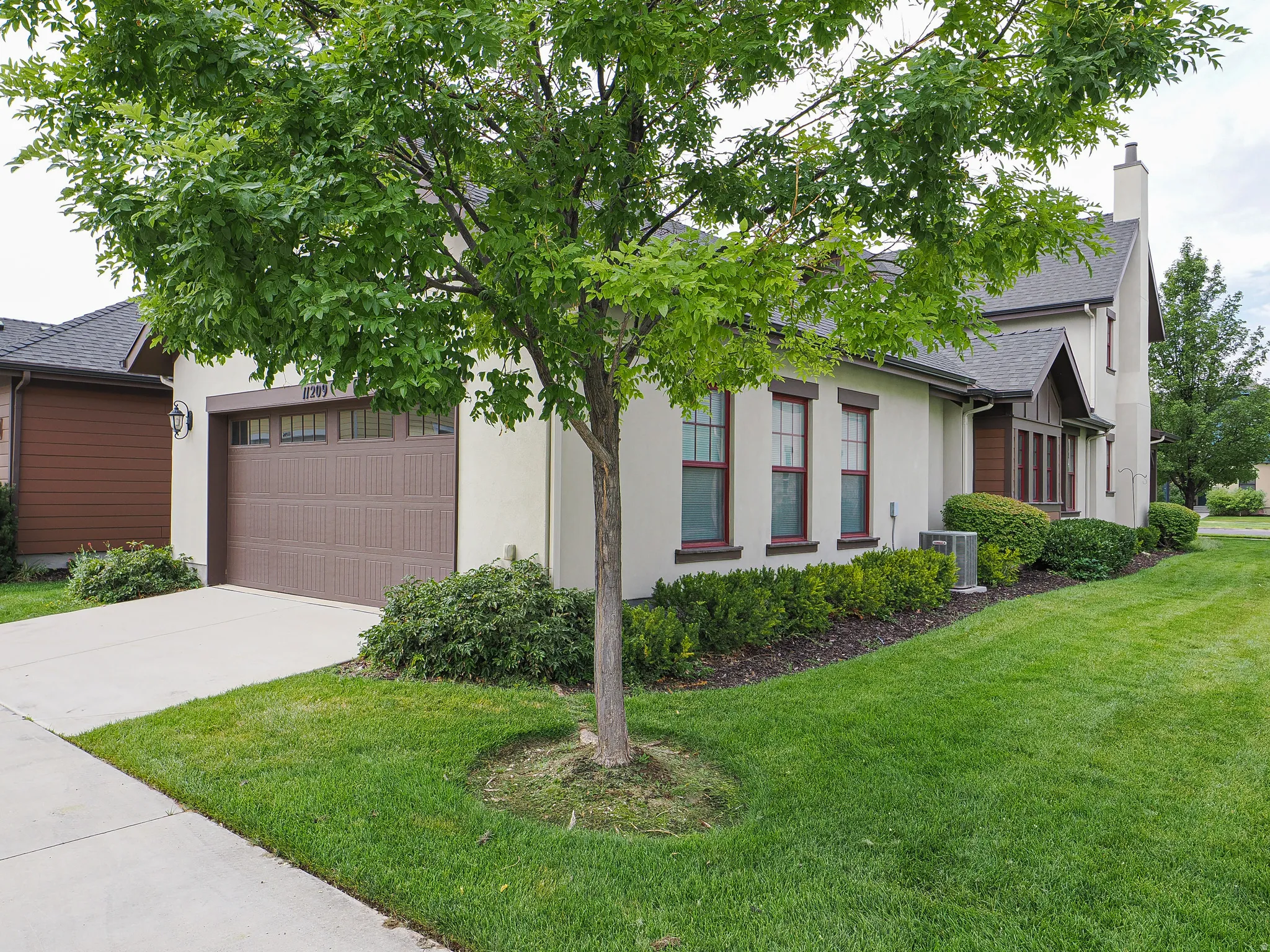 Stucco exterior with brown trim accents and a pitched roof