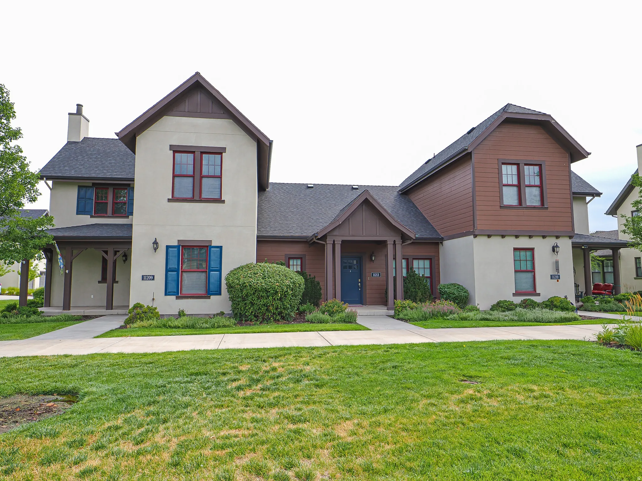 Stucco and wood-siding exterior with dark trim accents