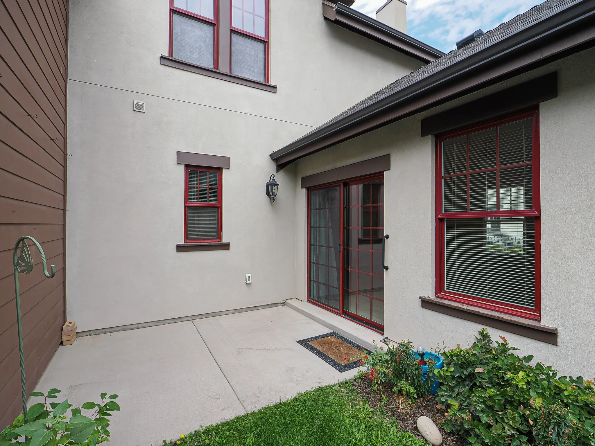 Exterior stucco finish with contrasting siding paneling