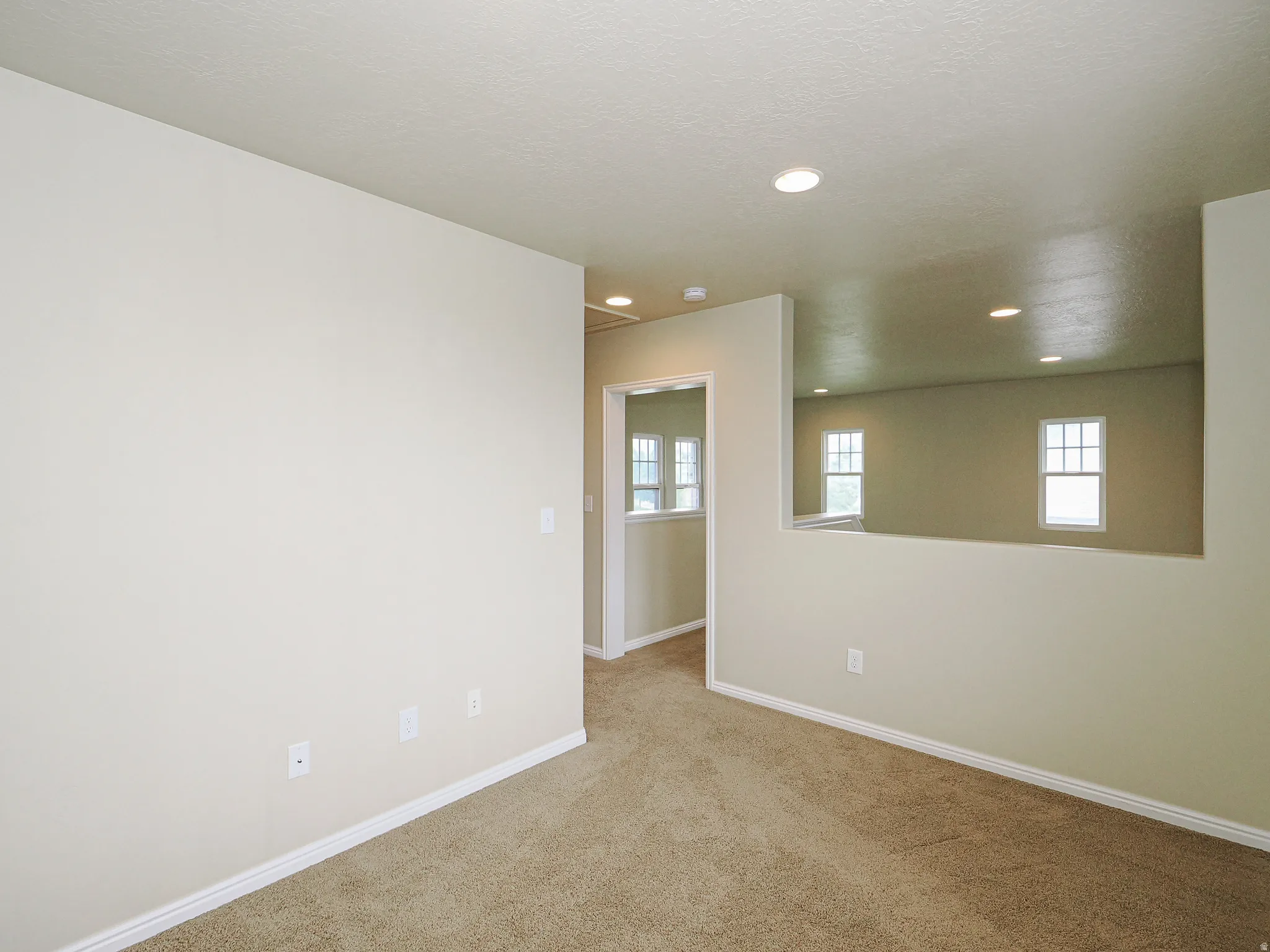 Interior space featuring neutral wall paint, recessed lighting, and carpet flooring