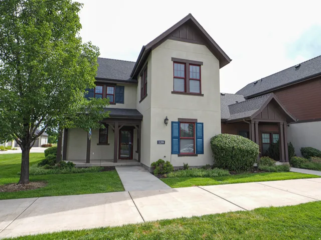 Two-story stucco exterior with contrasting trim and gabled rooflines