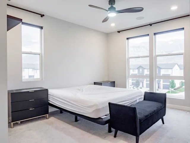 Spacious room featuring multiple large windows, recessed lighting, and a ceiling fan