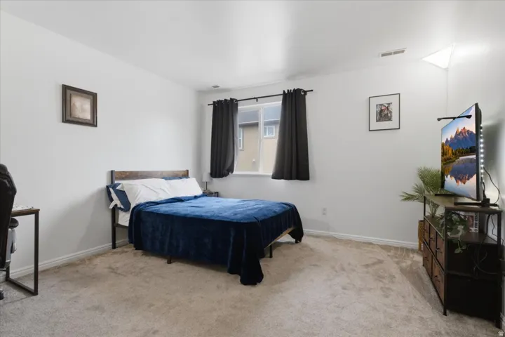 Carpeted room with a double window, white walls, and a ceiling vent