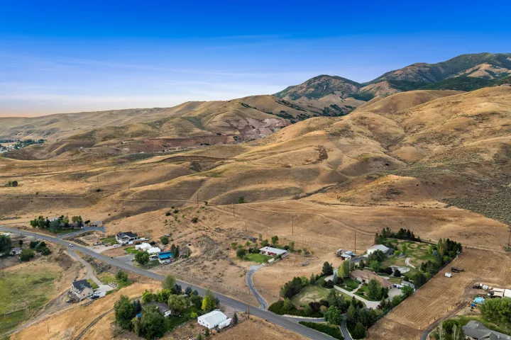 Expansive mountain backdrop featuring rolling hills and visible roadways