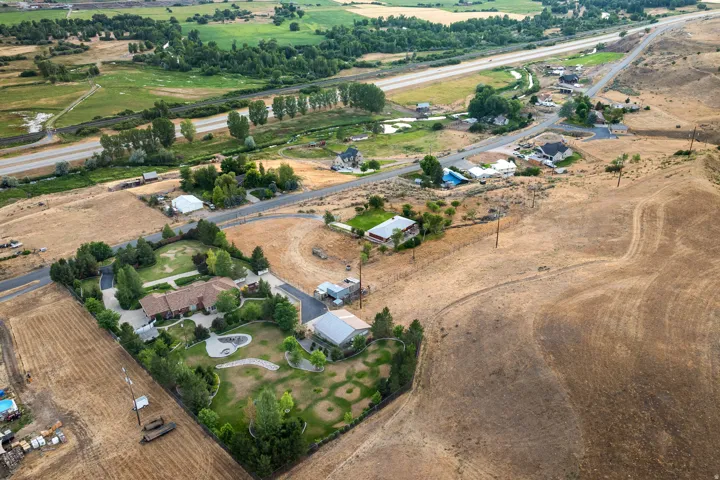 Expansive property featuring a large residence with a brick exterior and a paved circular driveway