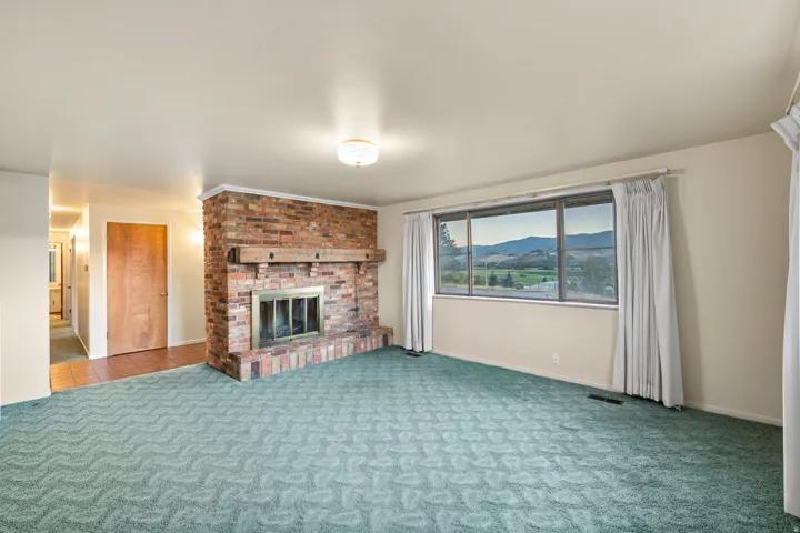 Brick fireplace with a substantial wood mantel