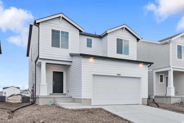 Modern two-story residence featuring light-colored horizontal siding and dark trim accents