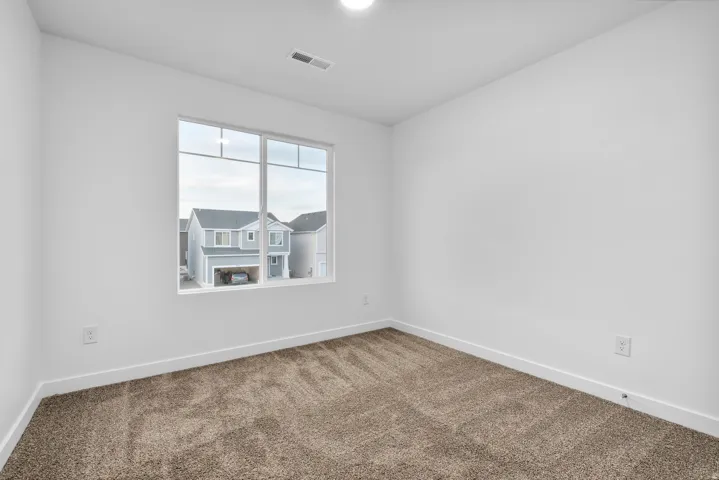 Room featuring neutral wall tones, plush carpet flooring, and white baseboards