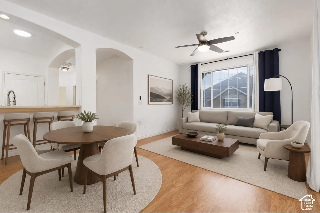 VIRTUALLY STAGED* Open-concept living area featuring wood-finish flooring and white walls