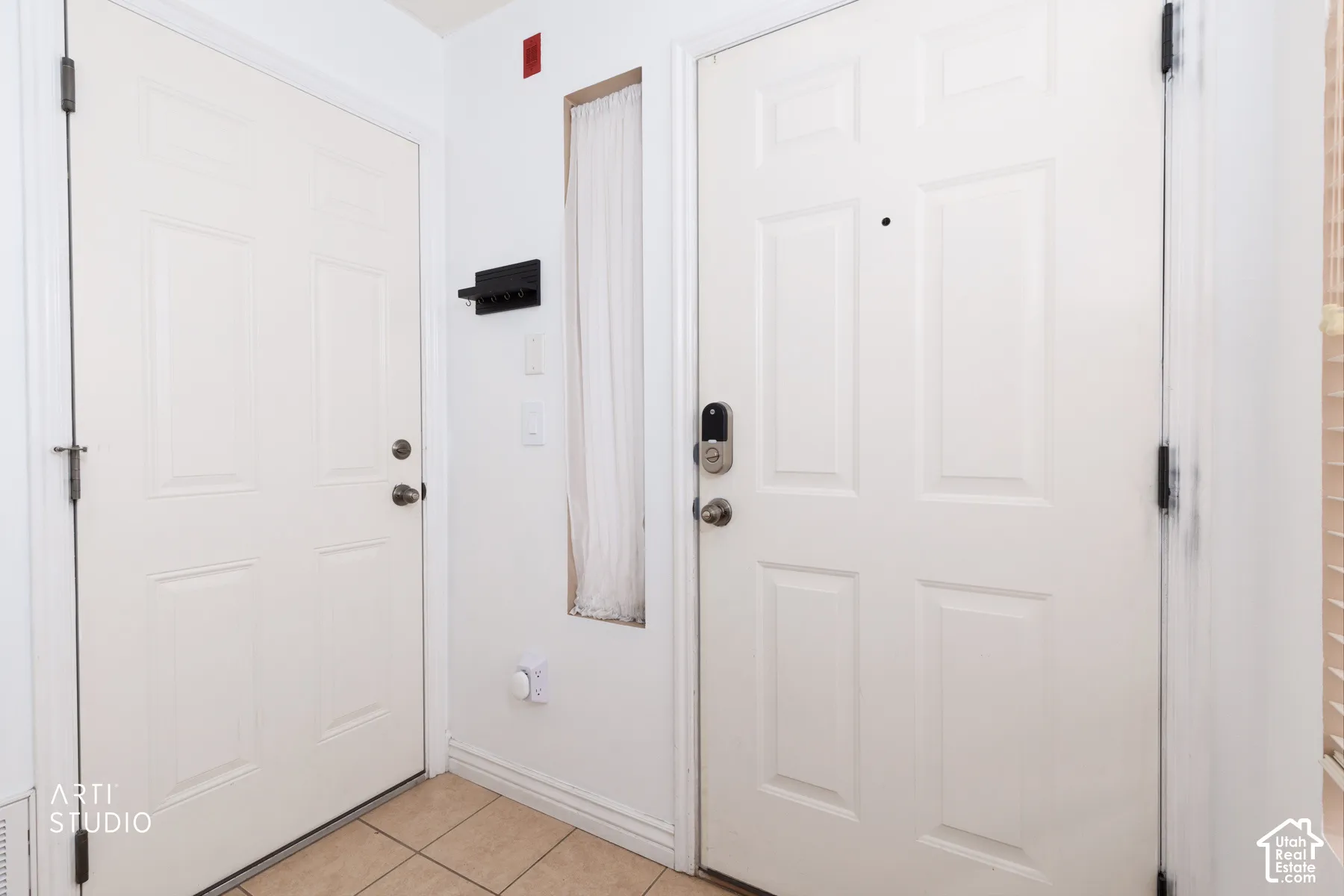 Entryway featuring two paneled doors, one equipped with a digital lock