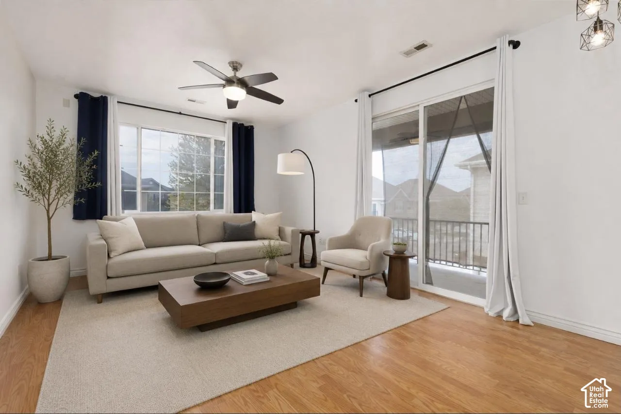 VIRTUALLY STAGED* Bright living area featuring wood-finish flooring and a neutral color palette