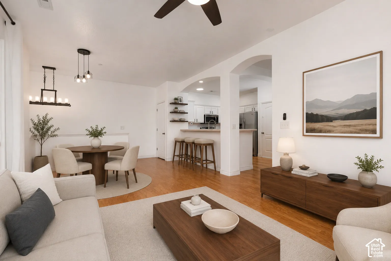 VIRTUALLY STAGED* Open-concept living space featuring wood-finish flooring, recessed lighting, and white walls