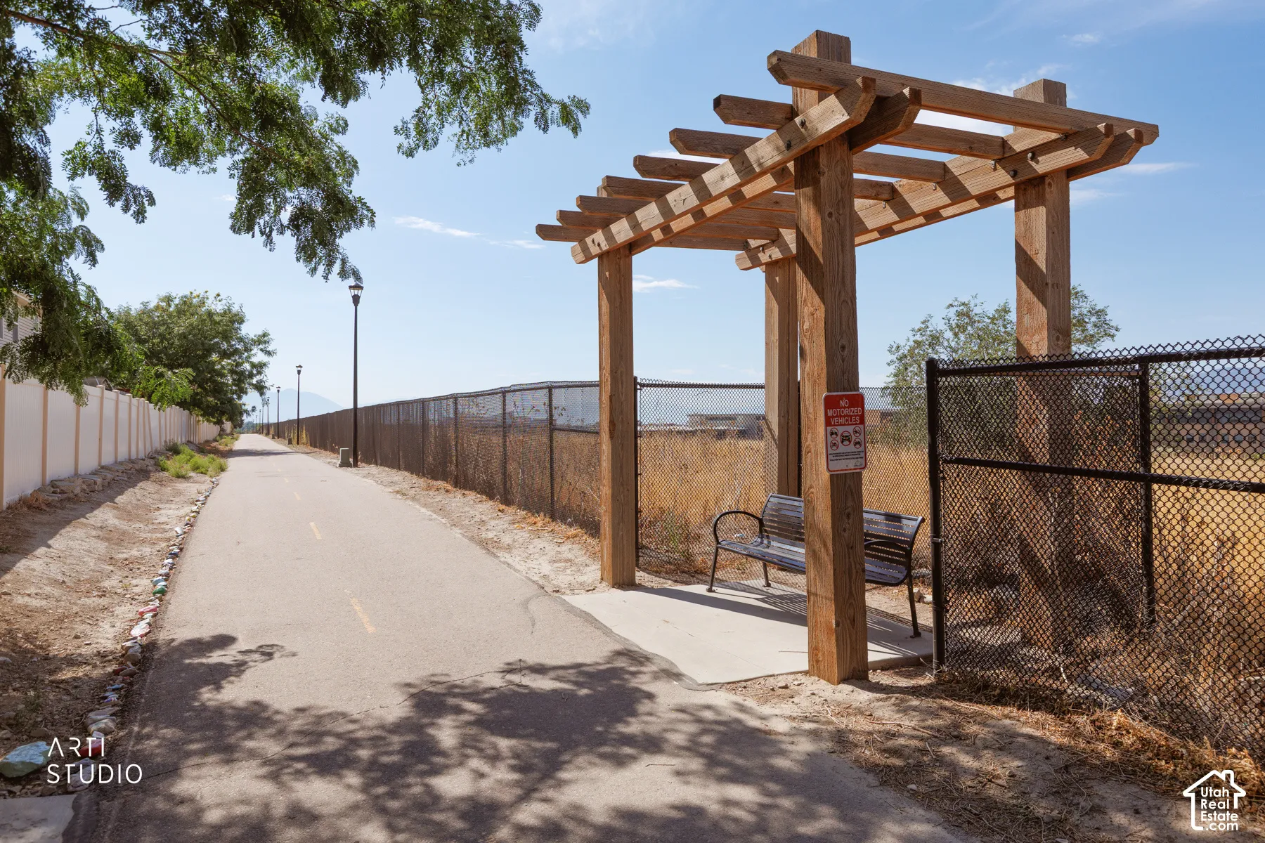 Paved pathway featuring a wood pergola and integrated bench seating