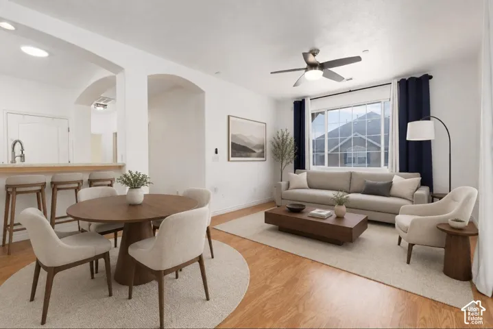 VIRTUALLY STAGED* Open-concept living area featuring wood-finish flooring and white walls