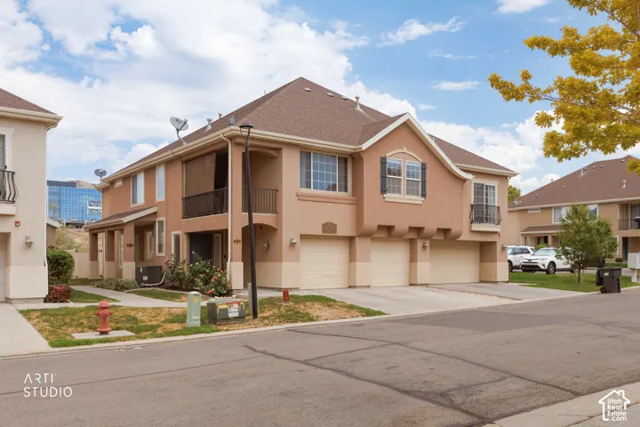 Stucco exterior featuring multiple attached garages