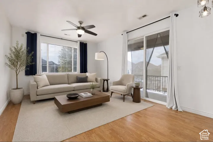 VIRTUALLY STAGED* Bright living area featuring wood-finish flooring and a neutral color palette