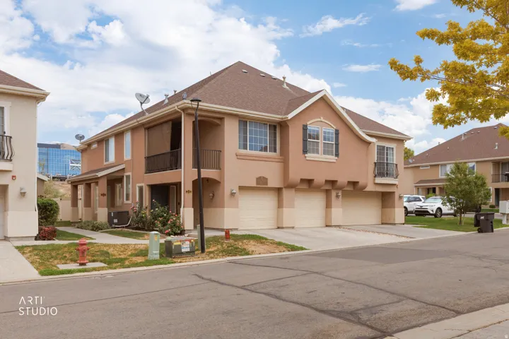 Stucco exterior featuring multiple attached garages