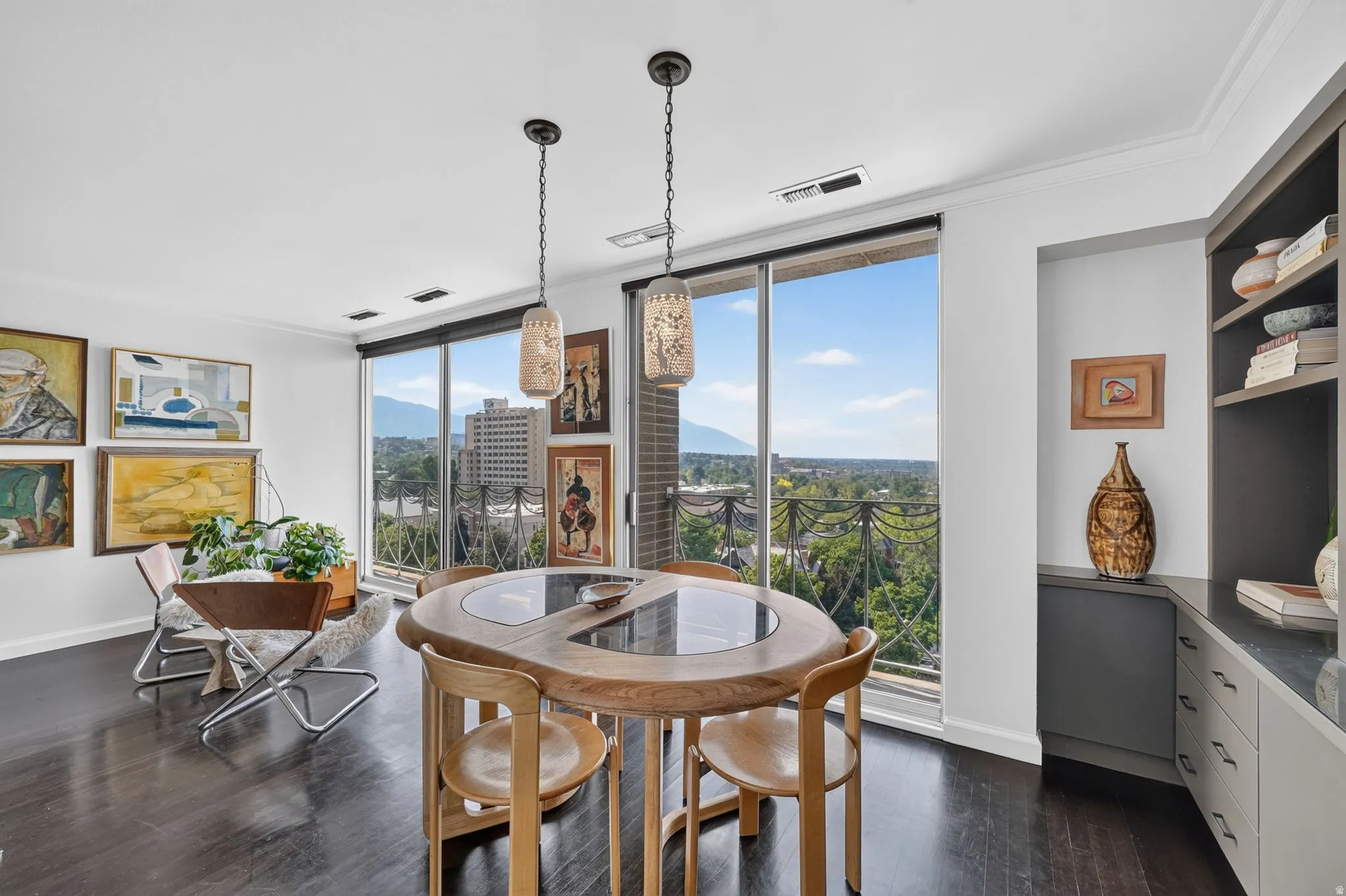 Expansive windows reveal distant mountain and cityscapes