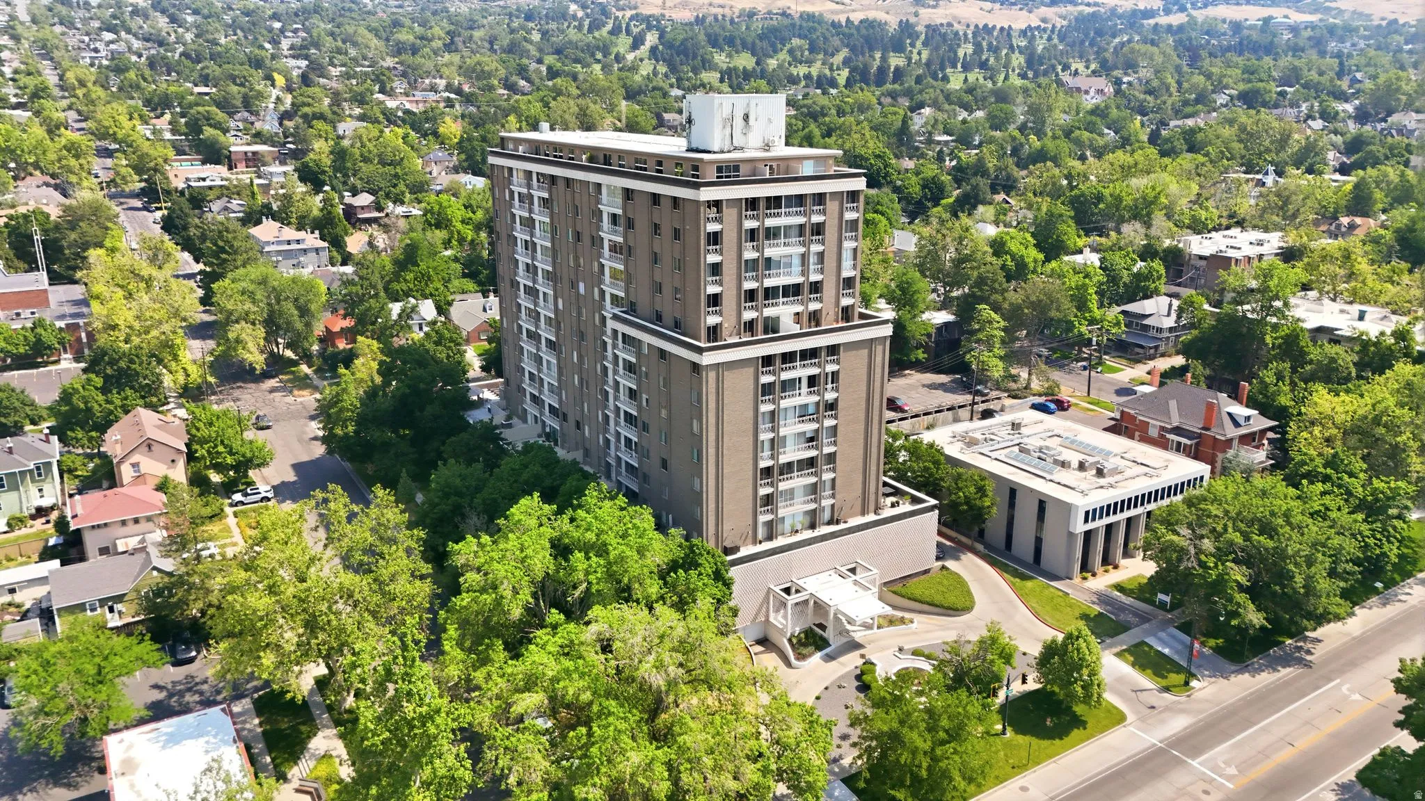 High-rise structure featuring multiple levels of balconies with glass railings
