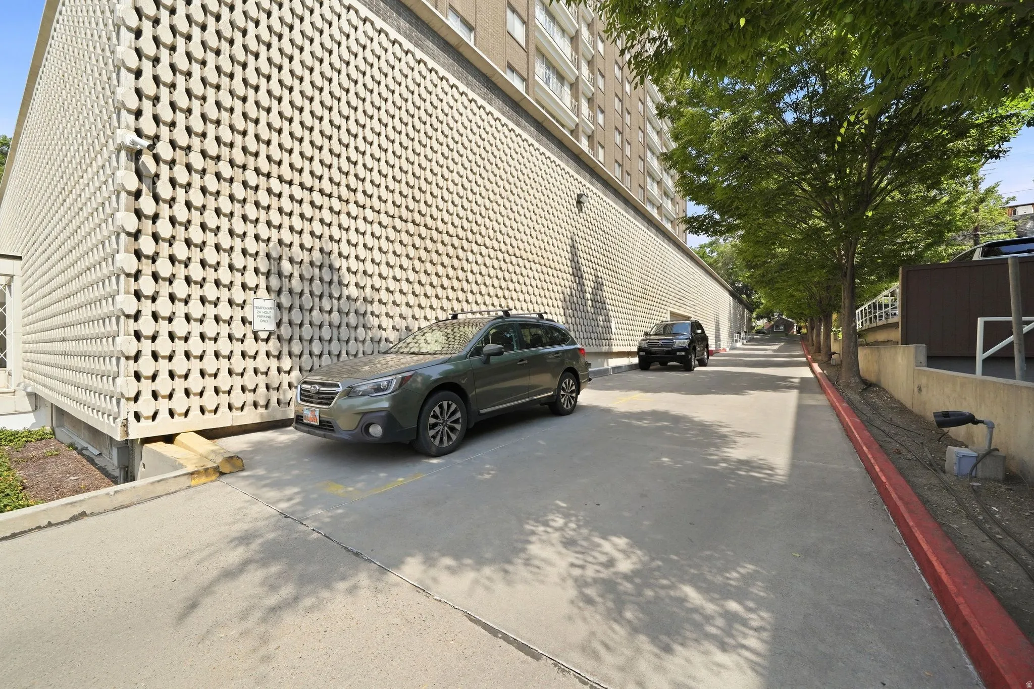 Exterior building wall featuring a repeating geometric pattern