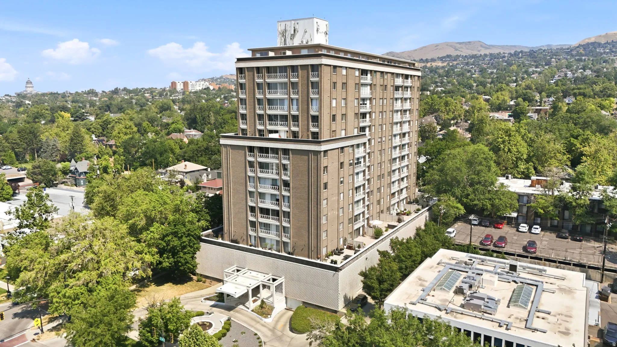 High-rise building featuring multiple stories and a brick-finish facade