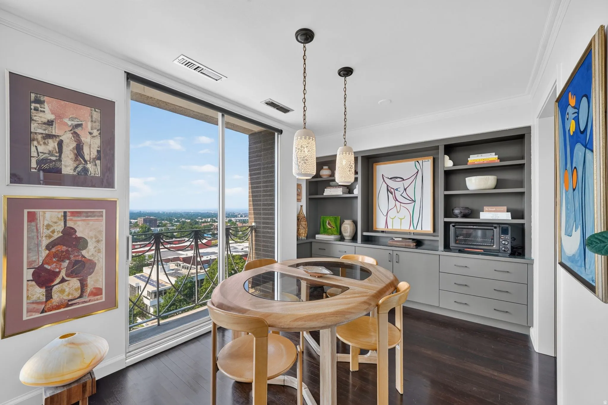 Floor-to-ceiling sliding glass doors open to a balcony with decorative railing