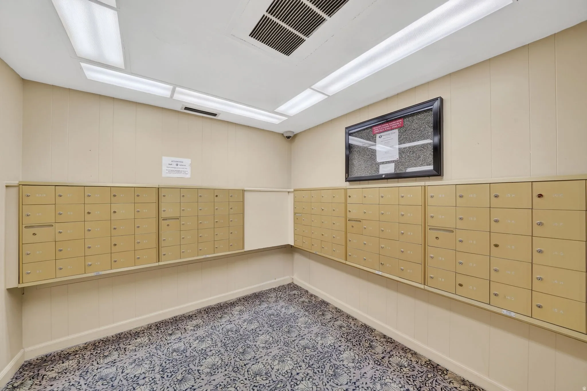 Mailroom featuring multiple rows of individual mailboxes