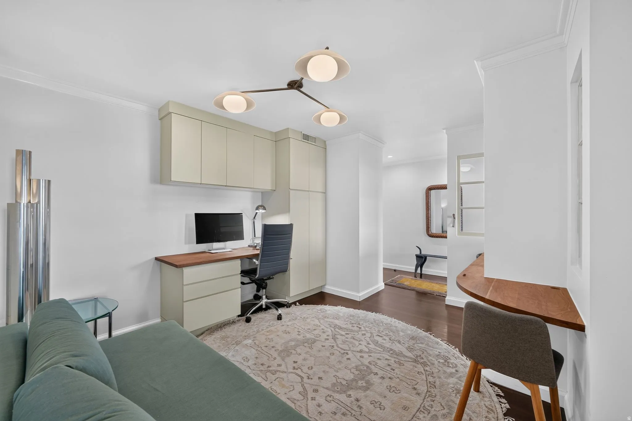 Integrated custom cabinetry with a wood-finish countertop workspace