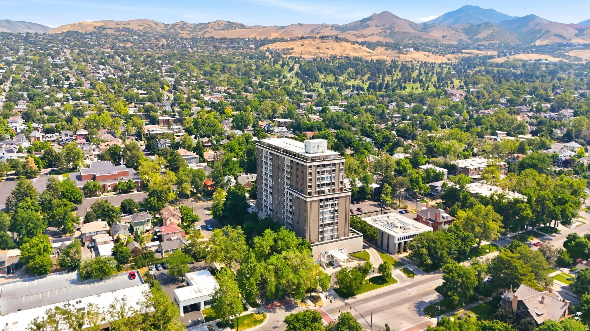 High-rise building featuring multiple balconies, a structured facade, and a flat roofline