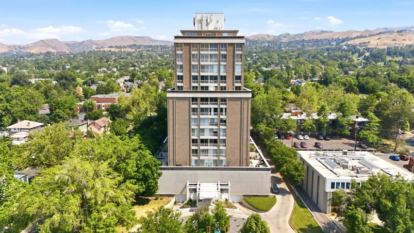 Multi-story building featuring a brick facade and numerous balconies