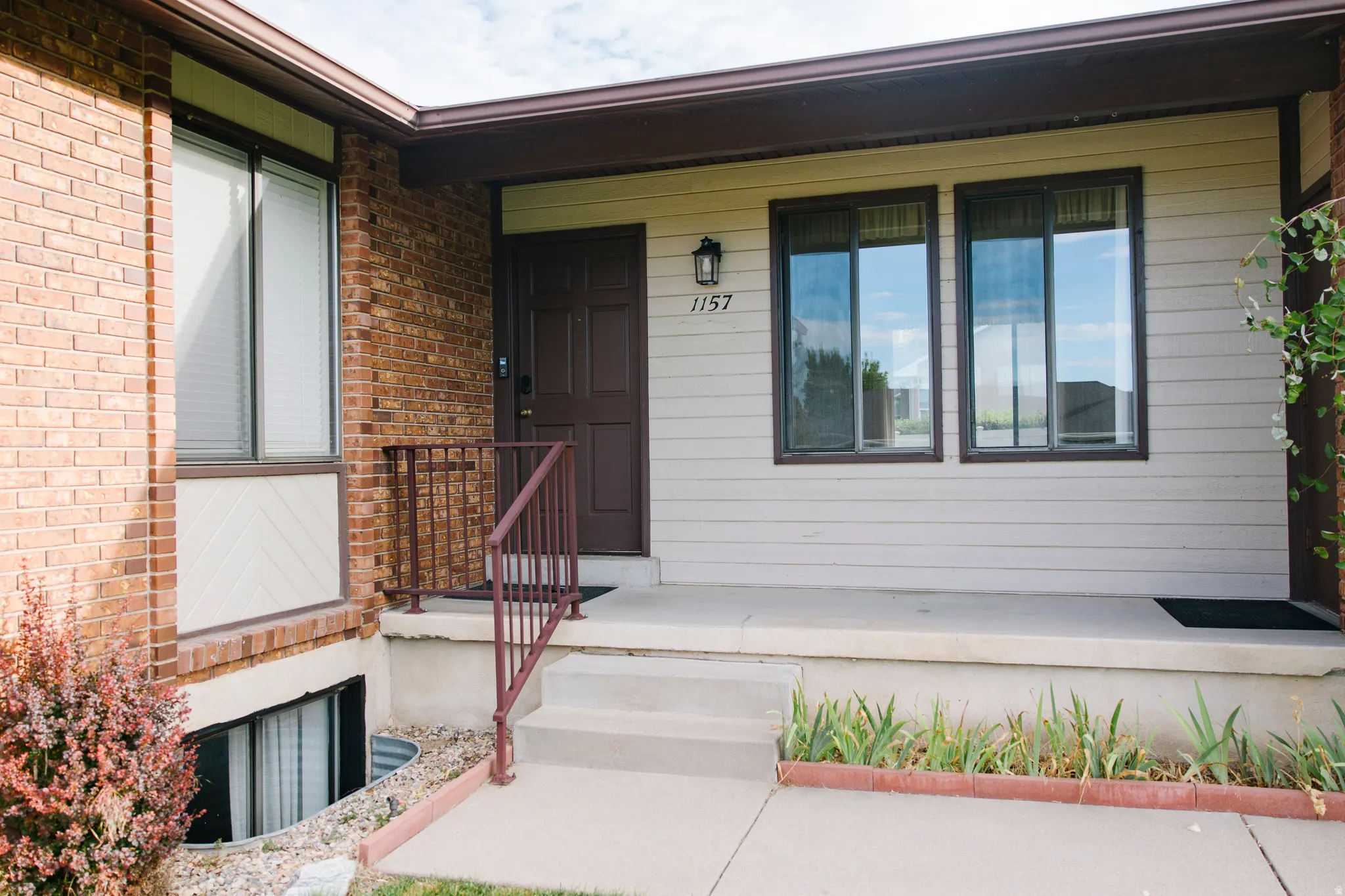 Exterior facade featuring brick and horizontal siding