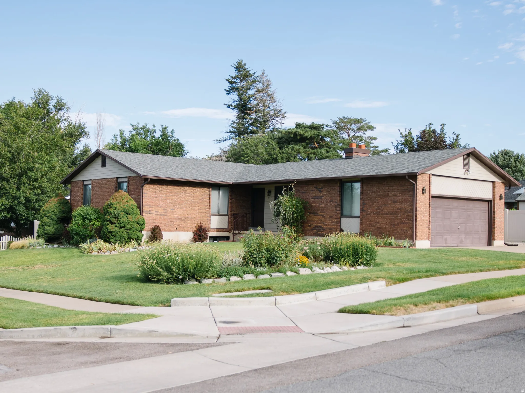 Brick exterior residence featuring a gabled roofline and attached garage