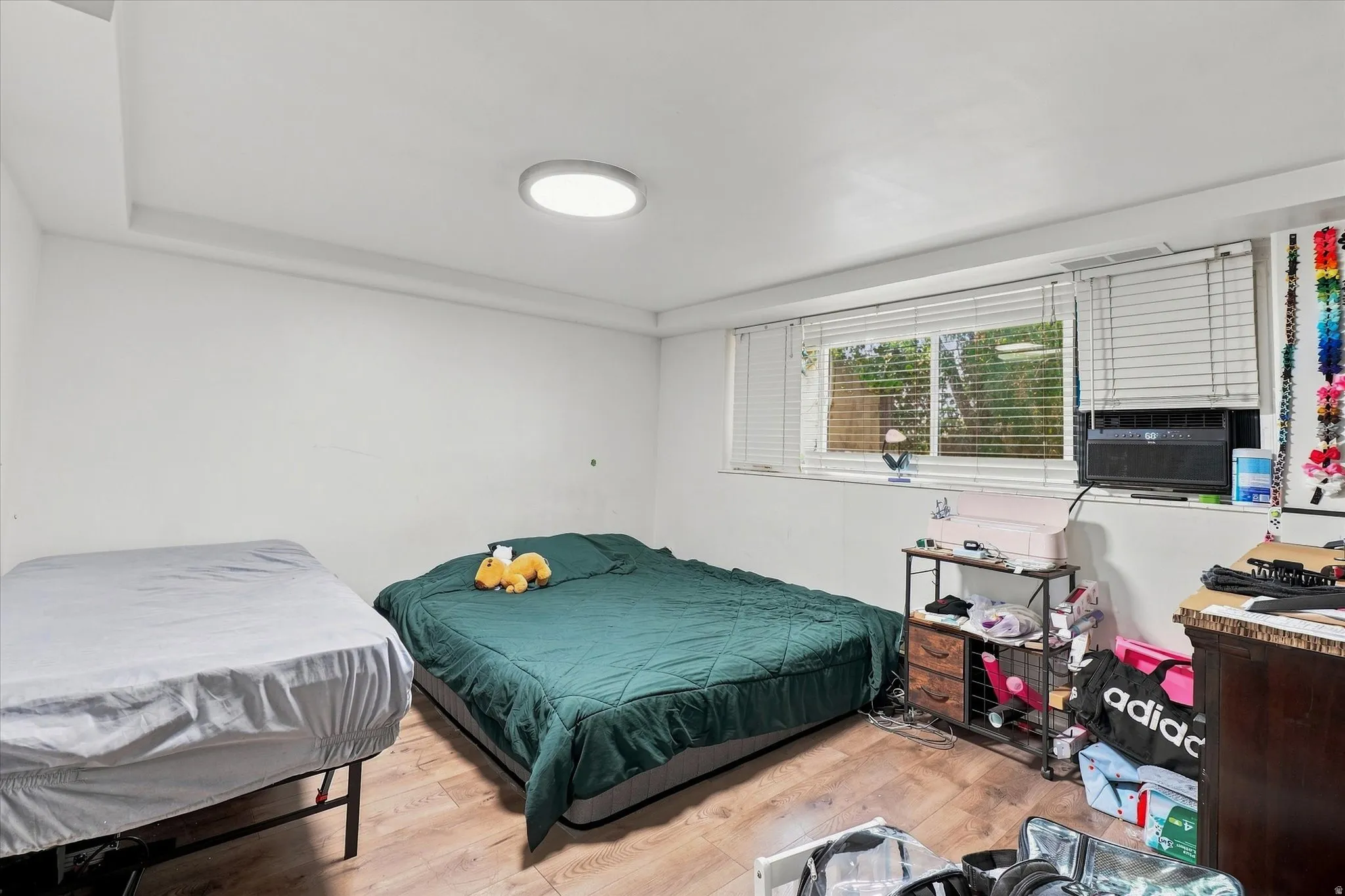 Wood-finish flooring with white walls and a drop ceiling