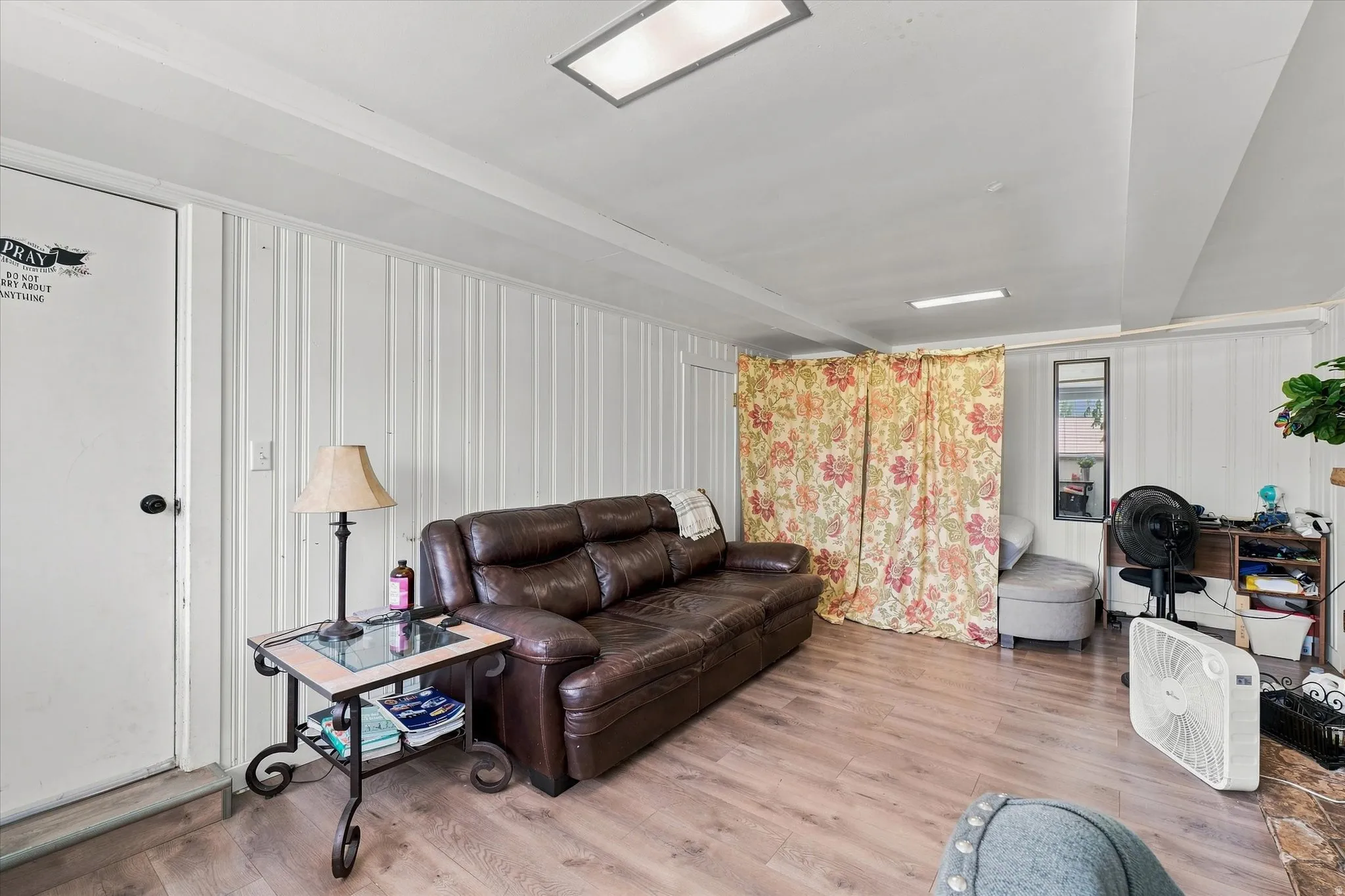 Wood-finish flooring with white vertical paneling